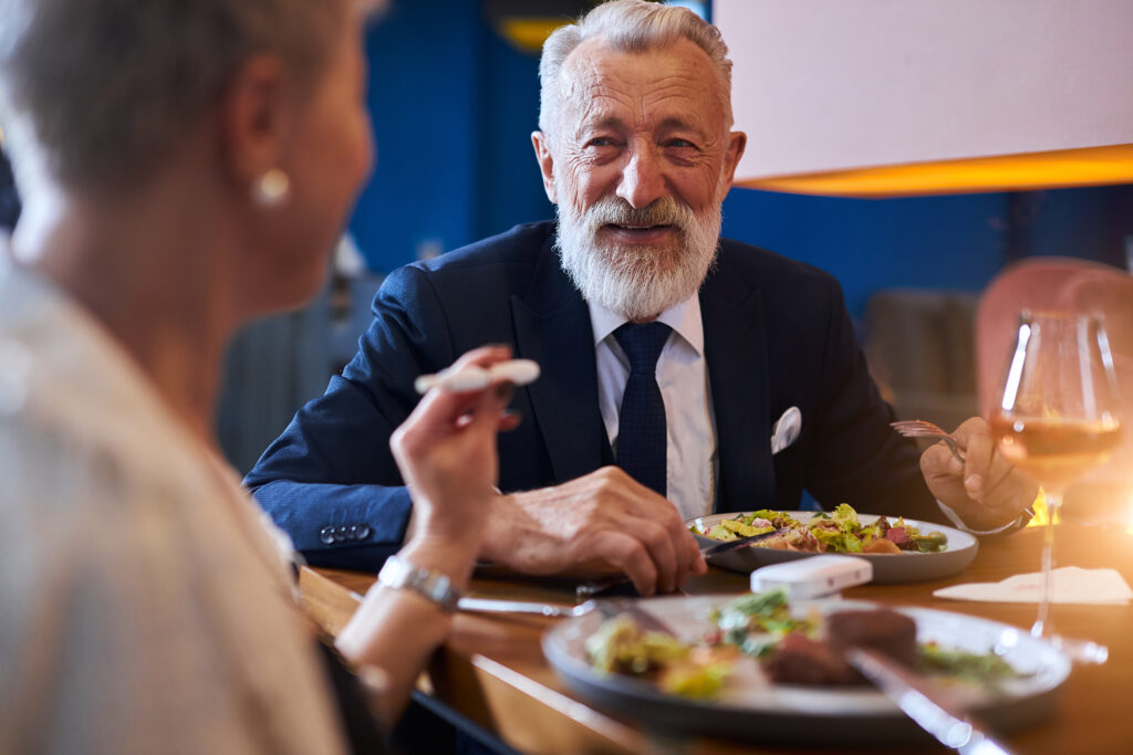 Senior caucasian couple have conversation over fining meal at restaurant